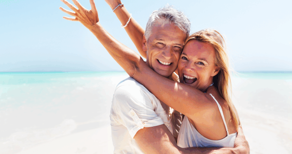 Couple celebrating their coaching wins on a beautiful beach.